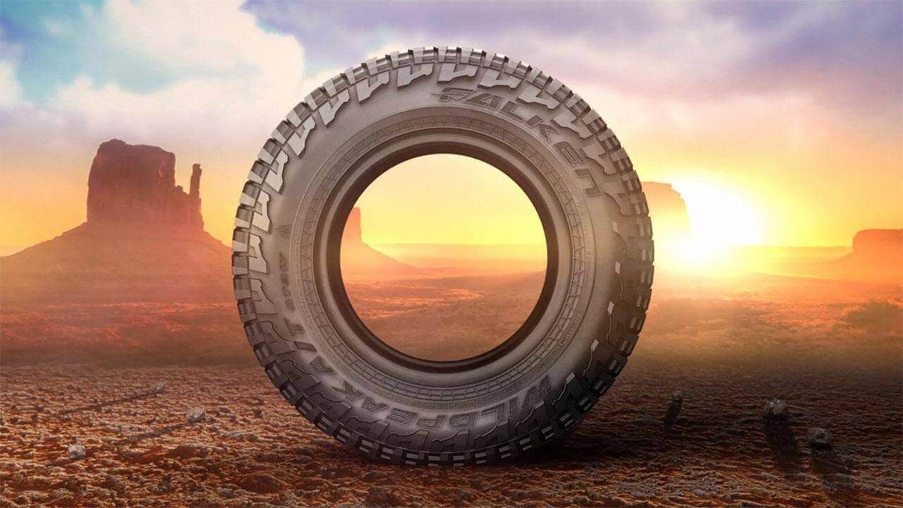 Large Falken Wildpeak AT3w tire on an off-road landscape background in a canyon