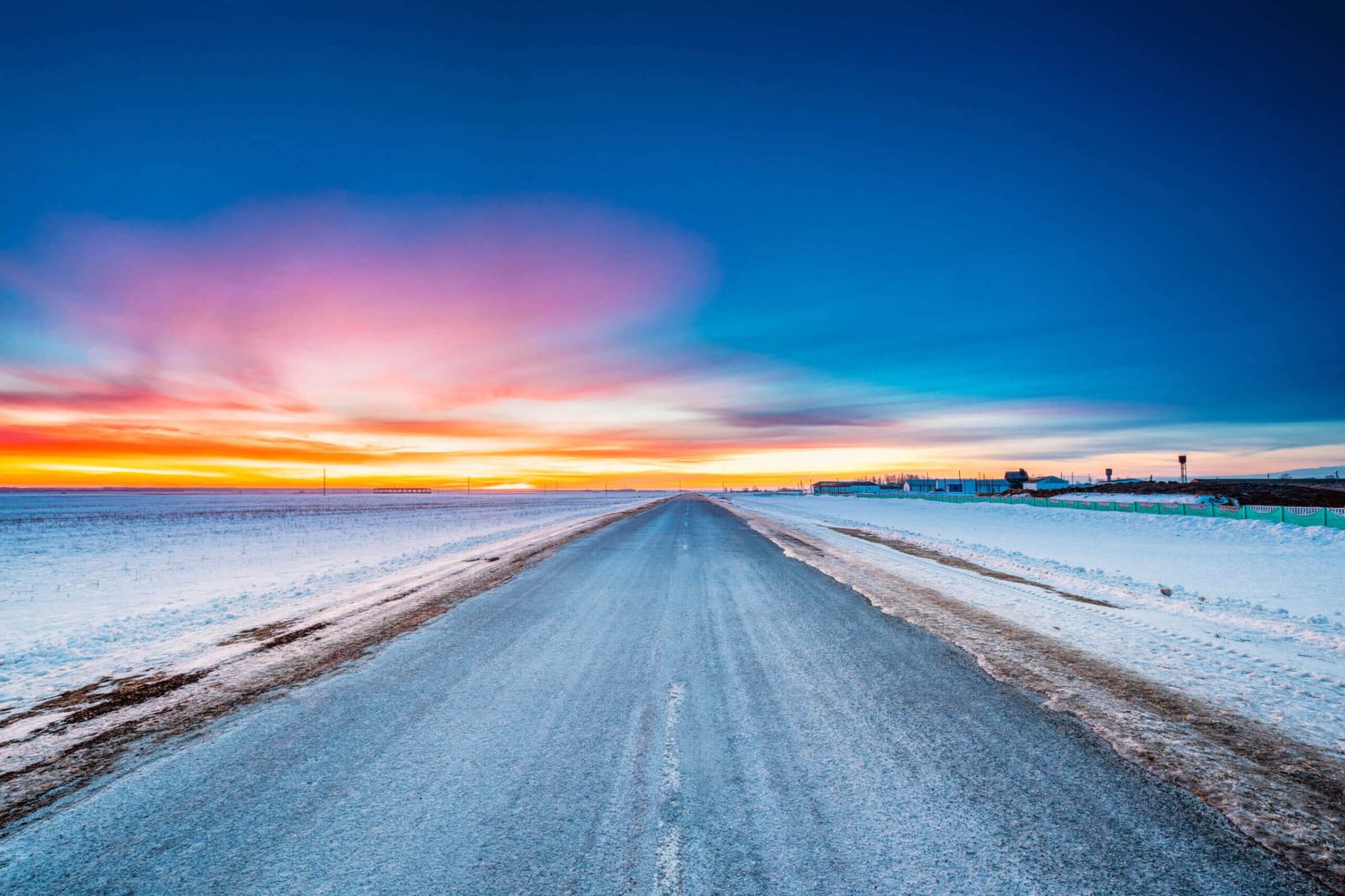 Asphalt Country open road through winter snowy fields and meadow