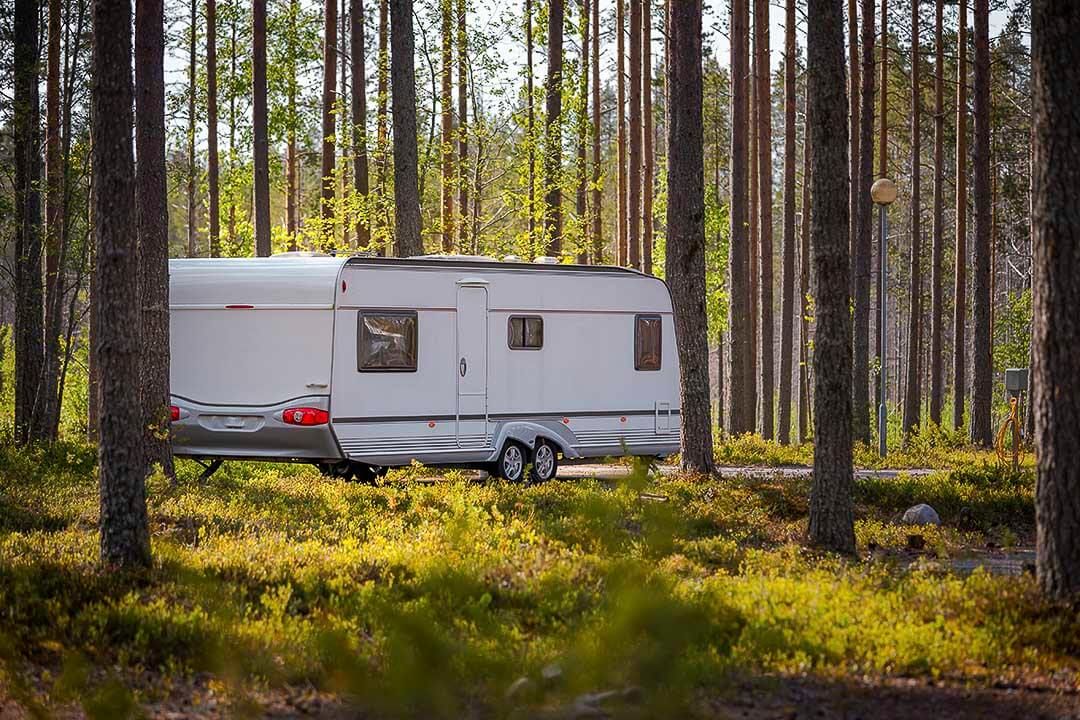 three quarter rear view of a parked travel trailer