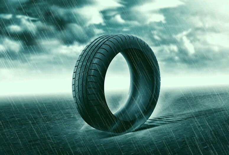 A summer tire driving on the road in a stormy downpour