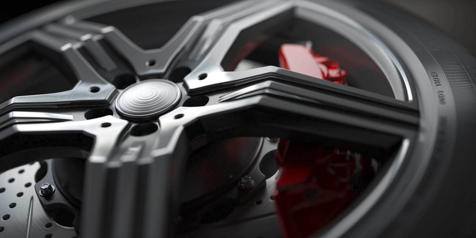 Alloy car wheel with disc brakes close-up background