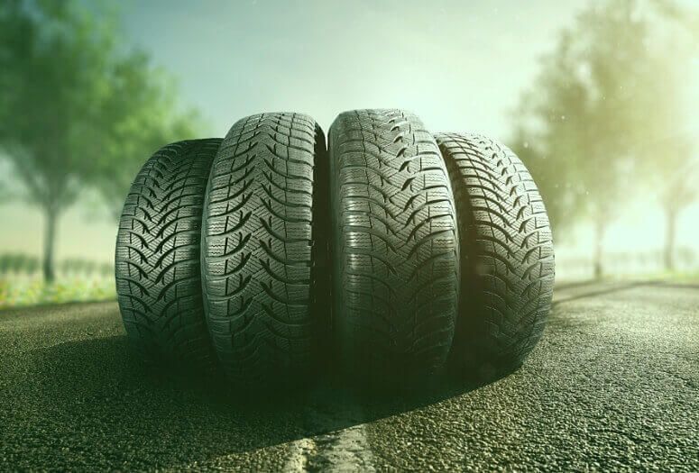 Four summer tires on the asphalt during a heatwave day