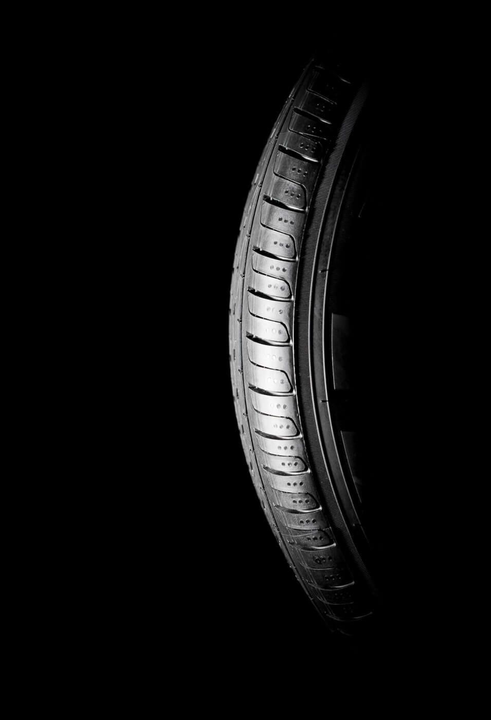 Bande de roulement d'un pneu clouté sur un fond noir