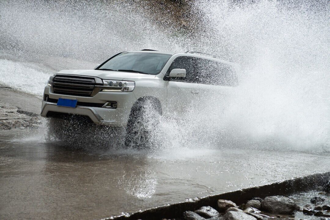 An SUV driving in rainy conditions