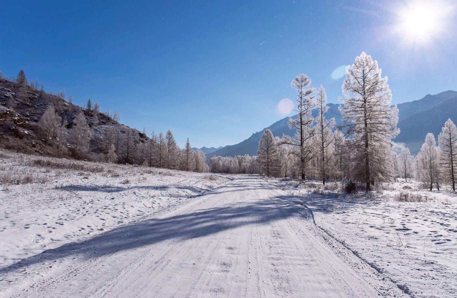 icy and snowy road in the mountains, sunny day