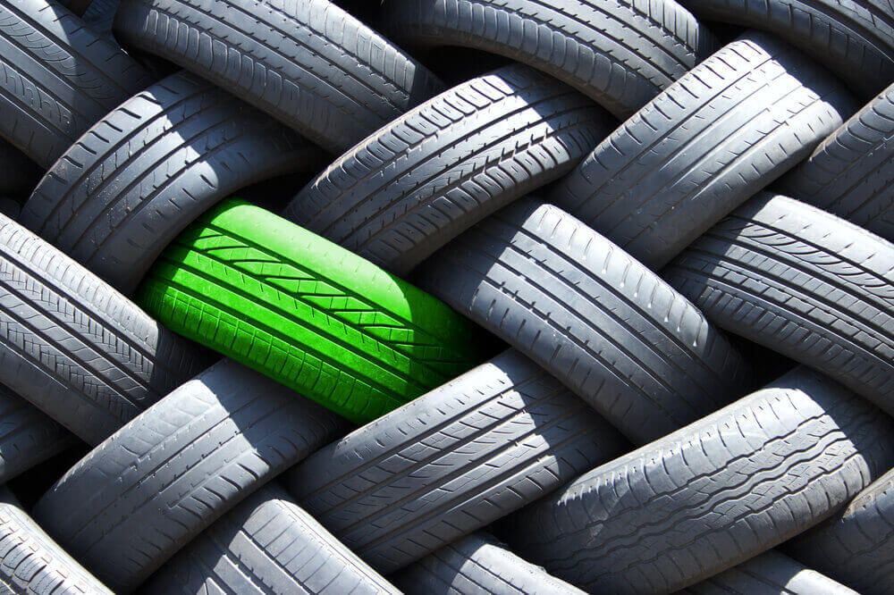 An ecological green tire among a large inventory of tires