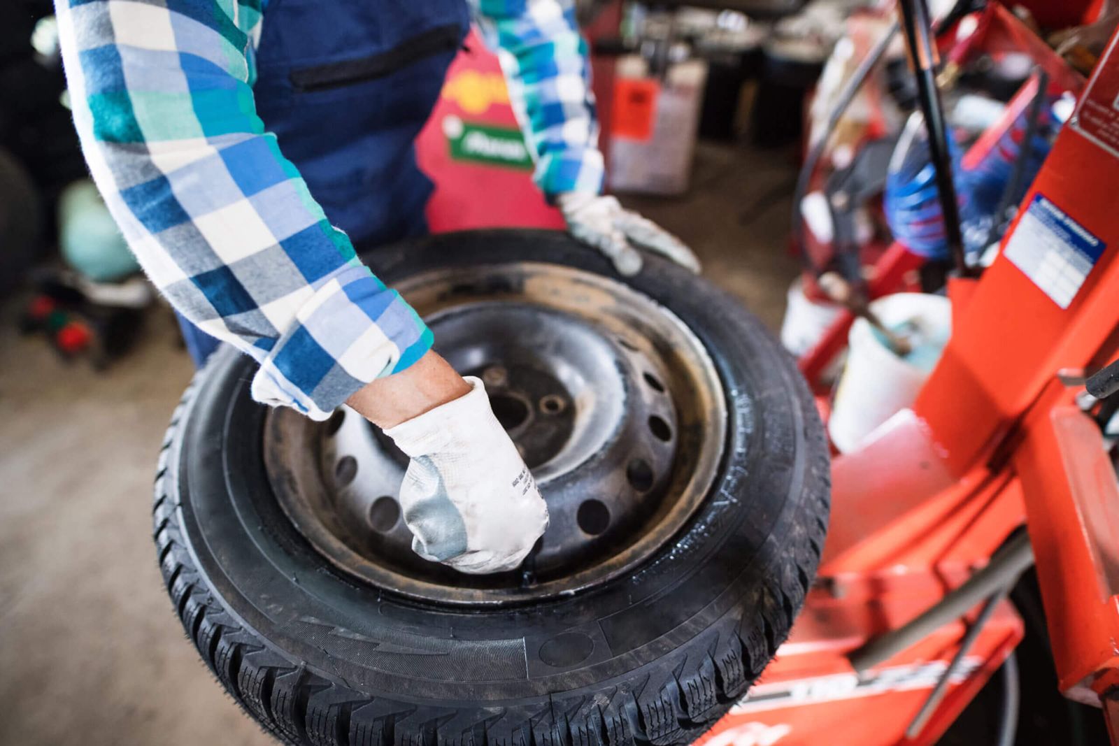 Senior mechanic repairing a car in a garage