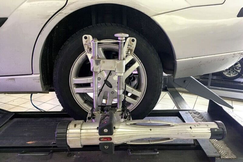 A car having its left rear tire aligned