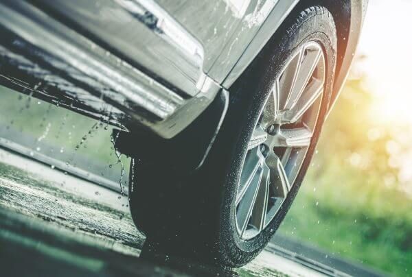 close up of a car tire on a wet surface