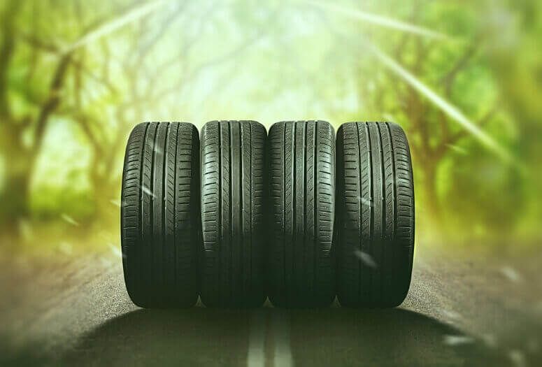 Four summer tires on the road during a hot summer day